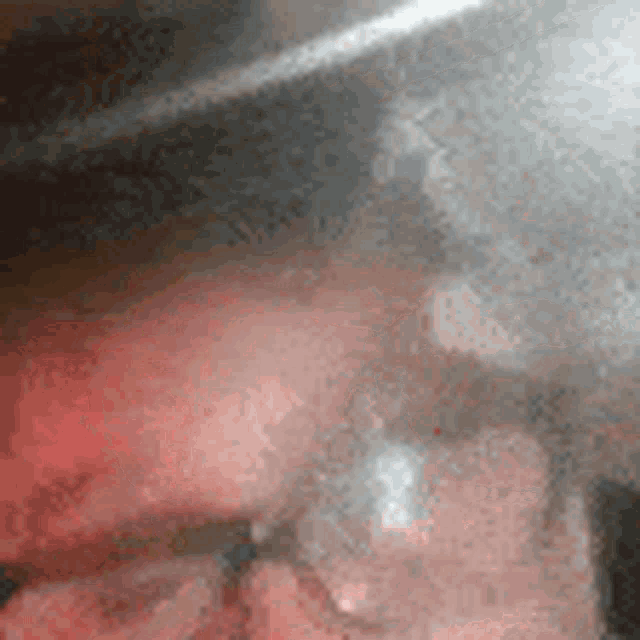 a close up of a person 's face with a red background