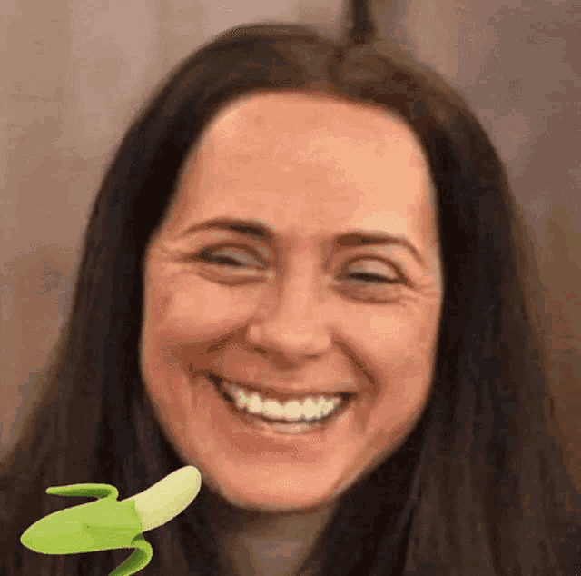 a close up of a woman 's face with a banana in front of her .