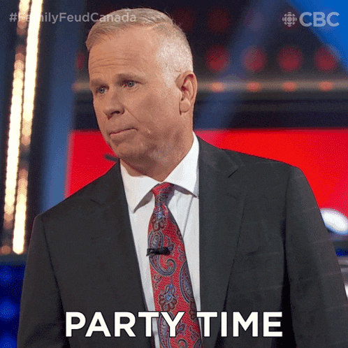 a man in a suit and tie says " party time " in front of a red background