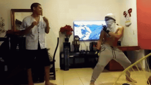 a man in a white shirt is standing next to a man in a white mask