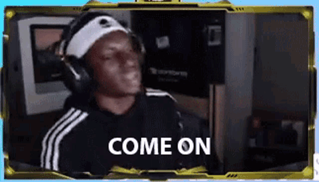a man wearing headphones and a headband is sitting in front of a computer and says `` come on '' .