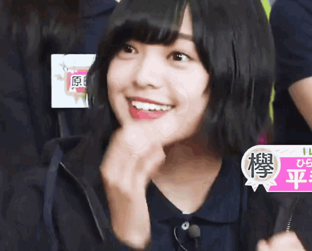 a girl with chinese writing on her shirt