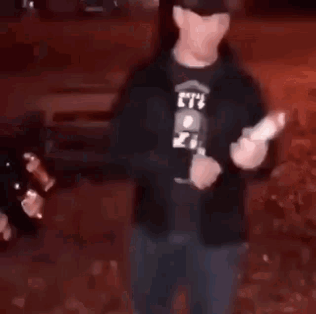 a man is dancing in front of a brick wall in a blurry photo .