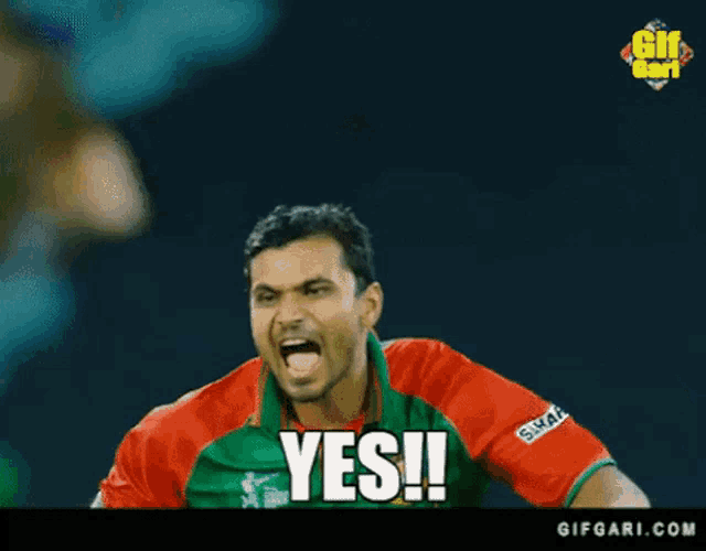 a man in a green and red shirt with the word yes written on his chest