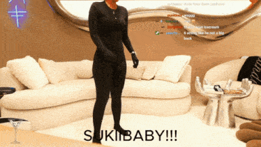 a woman in a black bodysuit is standing in front of a white couch with the words sukibaby !!! below her