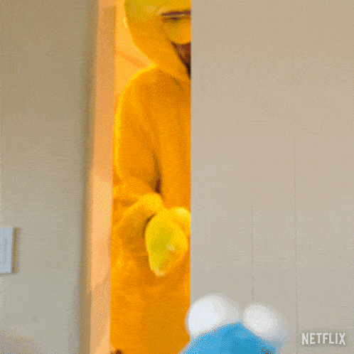 a man in a big bird costume is standing next to a netflix sign