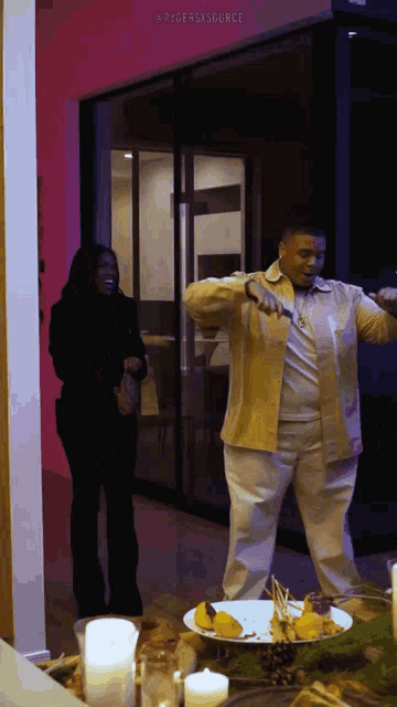 a man and a woman are dancing in front of a plate of food with the hashtag @ryderxsource