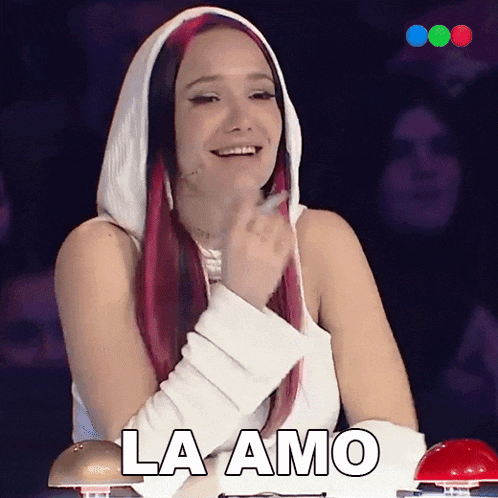 a woman with red hair and a white top says la amo