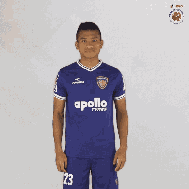 a soccer player wearing a blue apollo tyres jersey