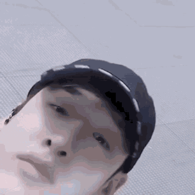 a close up of a person 's face wearing a hat .