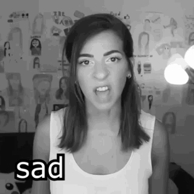 a black and white photo of a woman with the word sad in the corner