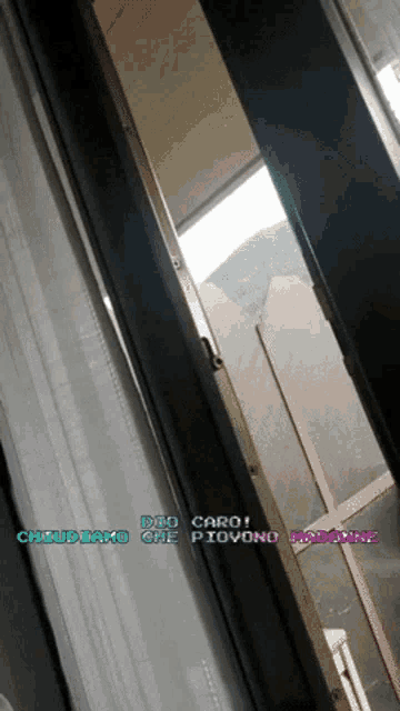 a picture of a window with the words dio caro written on it
