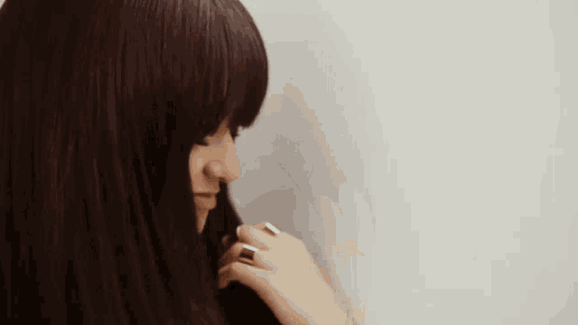 a woman with a ring on her finger is looking down