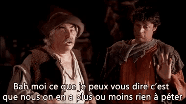 two men are standing next to each other and one of them is talking in a foreign language