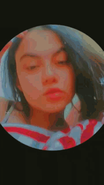 a close up of a woman 's face with her eyes closed .
