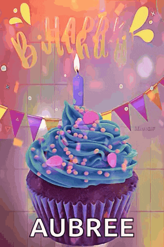 a purple cupcake with blue frosting and a lit candle with the name aubree on it