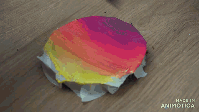 a colorful circle is being painted with a brush and the words made in animatica are visible