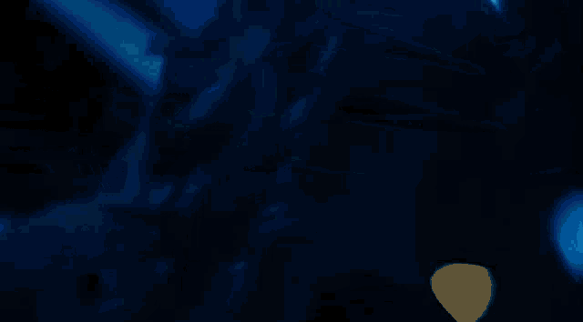 a woman is standing in a dark room with blue lights behind her