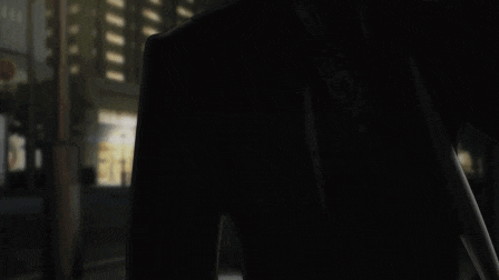 a man in a suit and tie is standing in a dark room