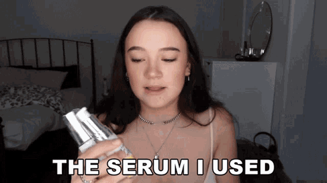 a woman holding a bottle of serum with the words the serum i used above her