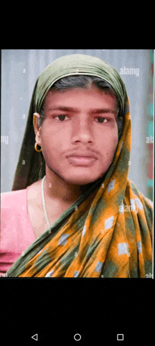 a man with a scarf around his head looks like a woman