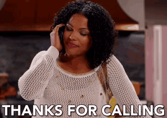 a woman is talking on a cell phone and saying thanks for calling