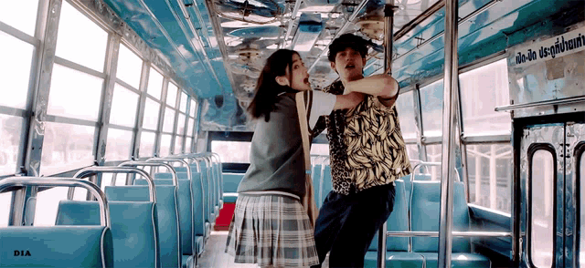 a man and a woman on a bus with dia written on the bottom left