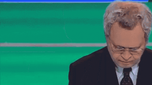 a man in a suit and tie is making a face