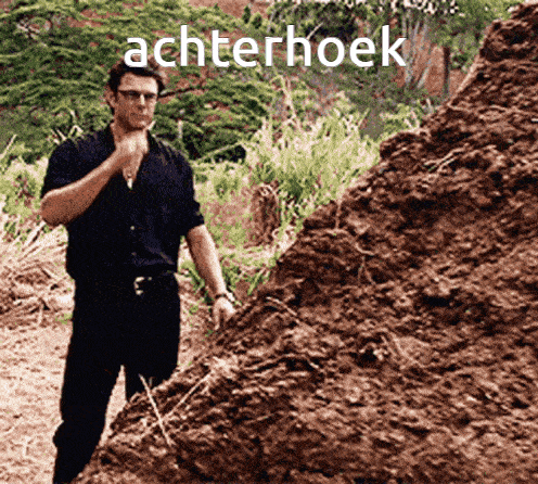 a man standing in front of a pile of dirt with the word achterhoek written on it