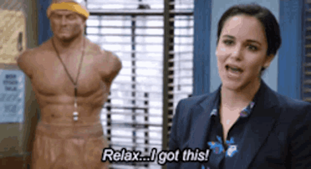 a woman in a suit says relax i got this in front of a statue of a man