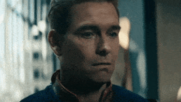 a close up of a man 's face with a superhero costume on .