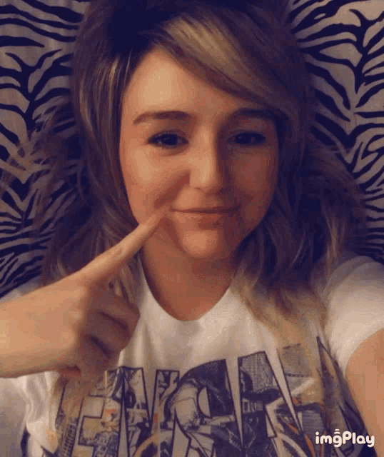 a woman wearing a t-shirt that says eminem is making a face