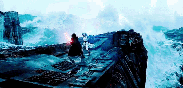 a couple of people are standing on top of a cliff holding lightsabers in front of a body of water .