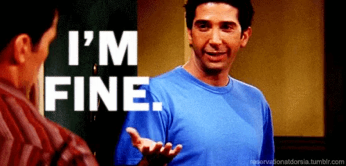 a man in a blue shirt is talking to another man with the words `` i 'm fine '' above him .