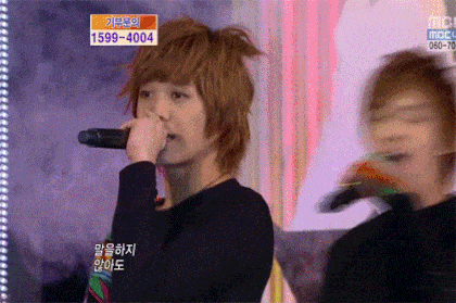 a person singing into a microphone with 1599-4004 written on the bottom