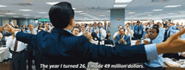 a man stands in front of a crowd with his arms outstretched and says the year i turned 26