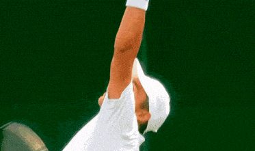 a man wearing a white hat is holding a tennis racquet