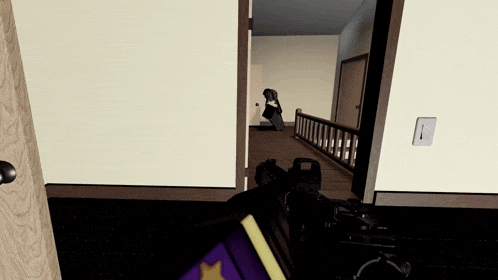 a person is holding a gun in a room with a door open