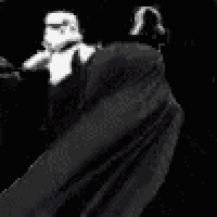 a black and white photo of a storm trooper and darth vader .