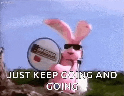 a pink bunny wearing sunglasses is holding a microphone and a drum and says `` just keep going and going '' .