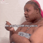 a woman with pink hair is talking to another woman while wearing a necklace .