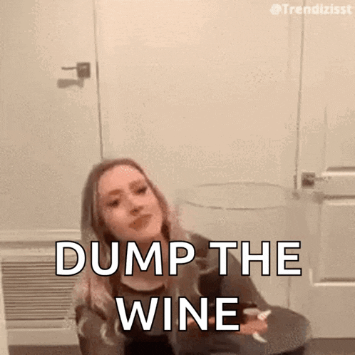 a woman is sitting in a chair holding a glass of wine and saying dump the wine .