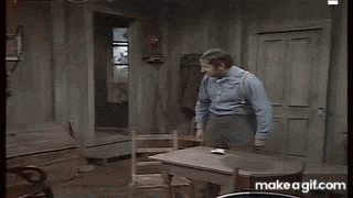 a man is jumping in the air while sitting on a chair .