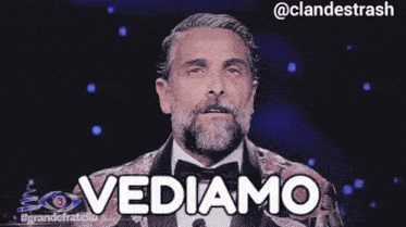 a man in a tuxedo with the word vediamo written on it