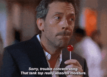 a man is holding a lollipop and saying sorry , trouble concentrating .