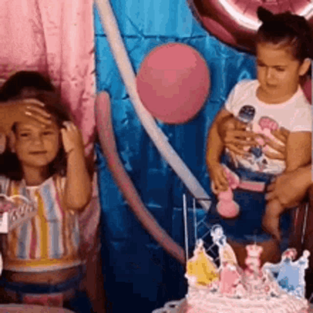 a little girl is cutting a birthday cake with a princess on it .