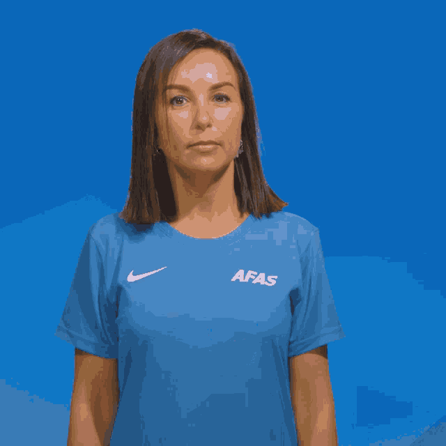 a woman wearing a blue shirt that says afas on it
