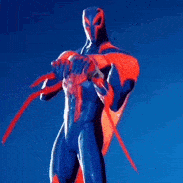 a statue of a man in a spiderman costume with a red cape holding a sword .