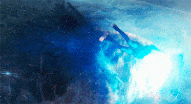 a person is flying through the air with a light behind them