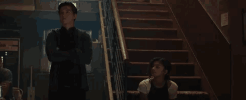 a man and a woman standing on a set of stairs